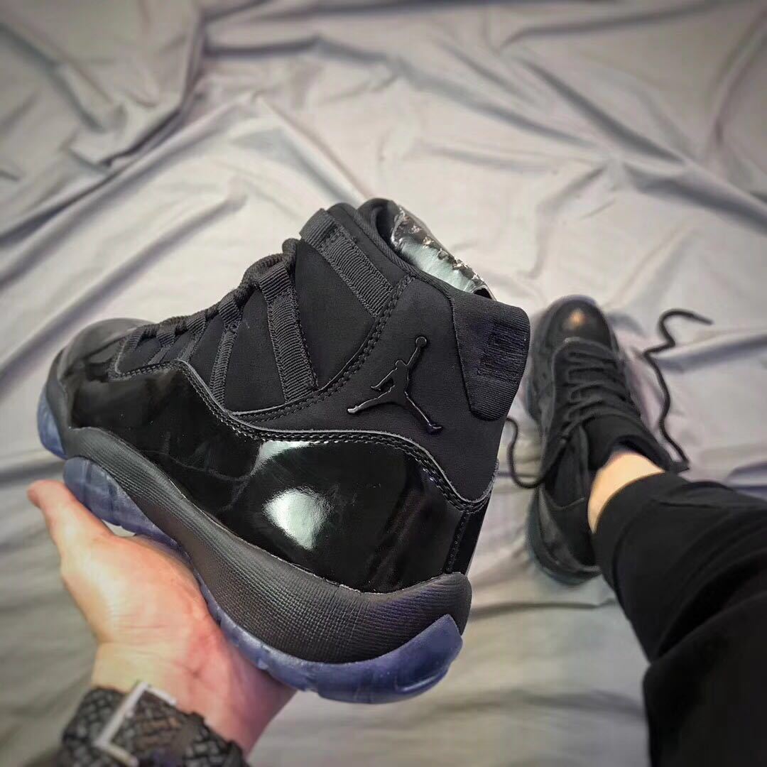 Air Jordan 11 Cap and Gown High-Top Sneakers in Black - product image from the listing.