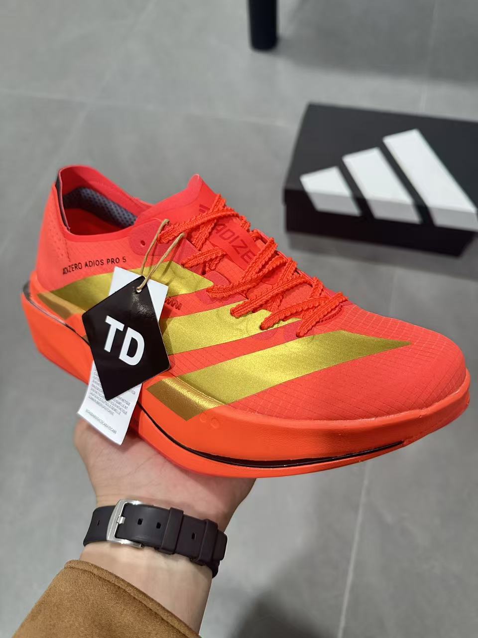 Adidas Adizero Adios Pro 5 Running Shoes, in Red and Lime - product image from the listing.