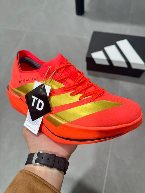 Adidas Adizero Adios Pro 5 Running Shoes, in Red and Lime - product image from the listing.
