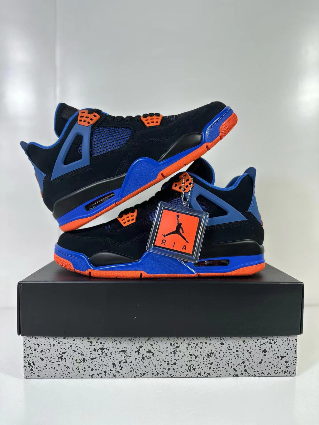 Air Jordan 4 Retro Black Blue Orange Sneakers - product image from the listing.