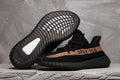 Yeezy Boost 350 V2 Sneakers in Black and Tan - product image from the listing.