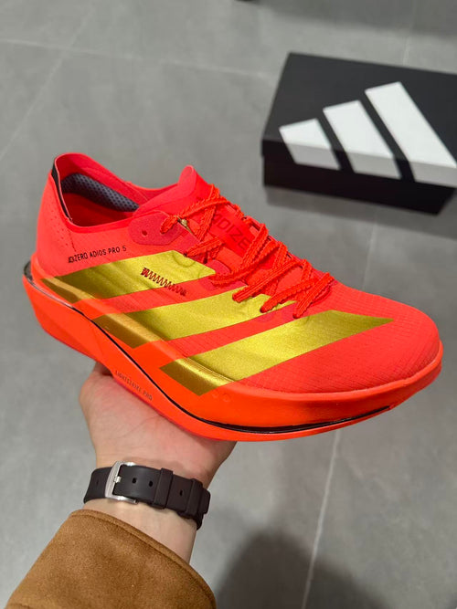 Adidas Adizero Adios Pro 5 Running Shoes, in Red and Lime - product image from the listing.