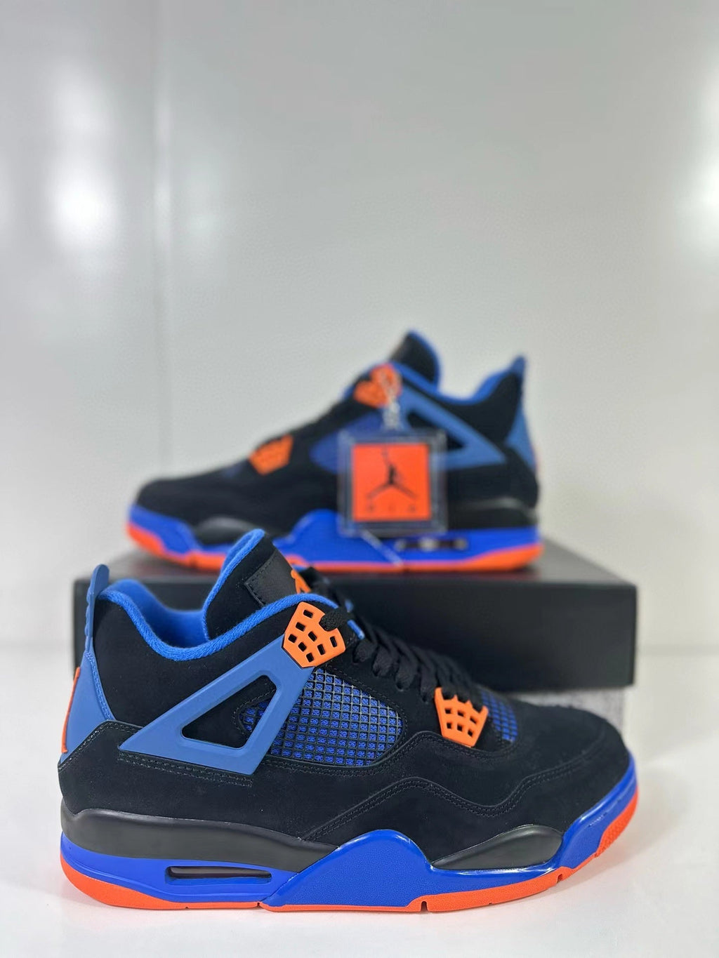 Air Jordan 4 Retro Black Blue Orange Sneakers - product image from the listing.