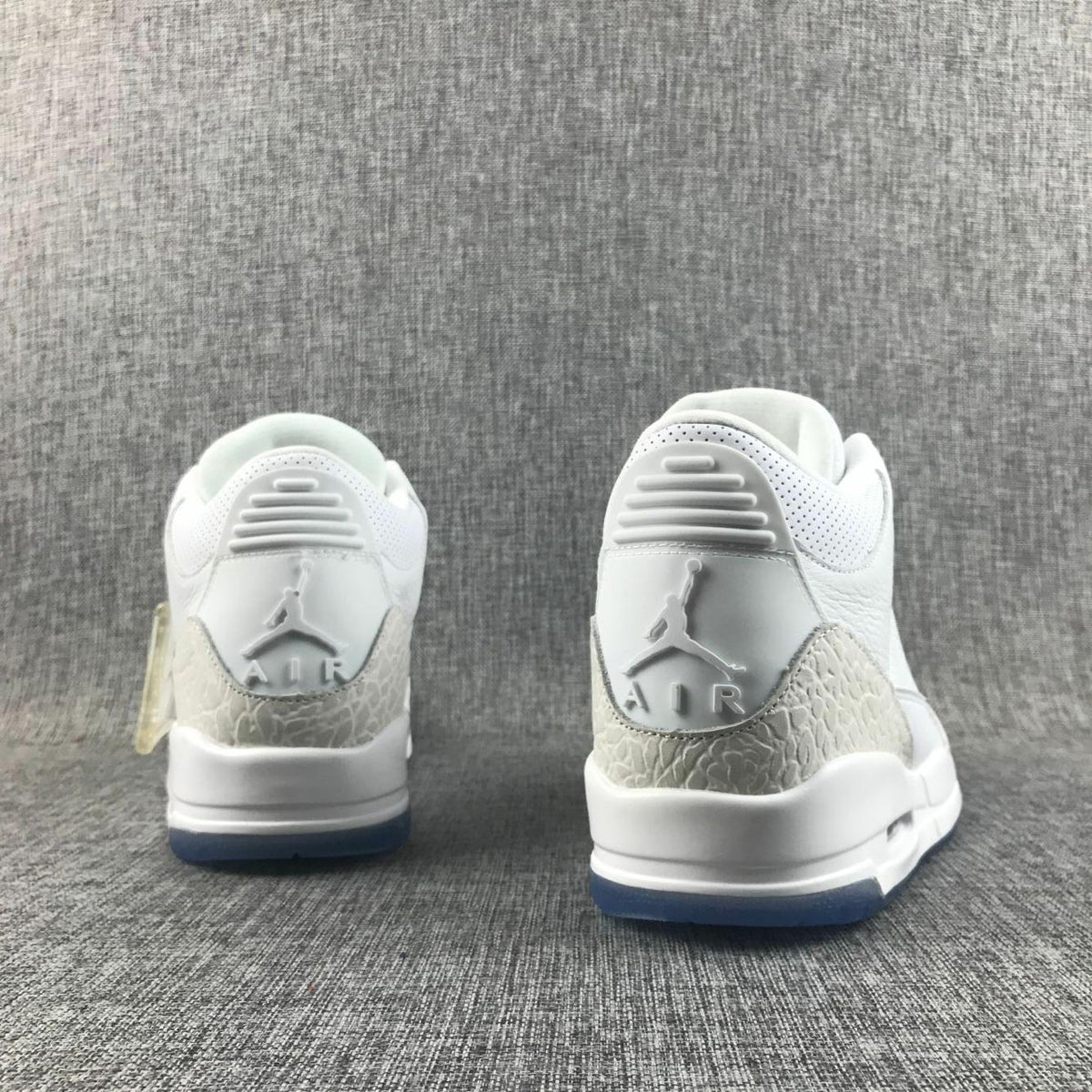 White Cement Sneakers with Blue Translucent Sole - Jordan 3 - product image from the listing.