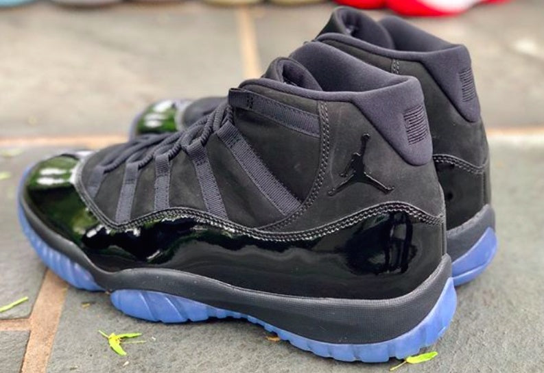 Air Jordan 11 Cap and Gown High-Top Sneakers in Black - product image from the listing.