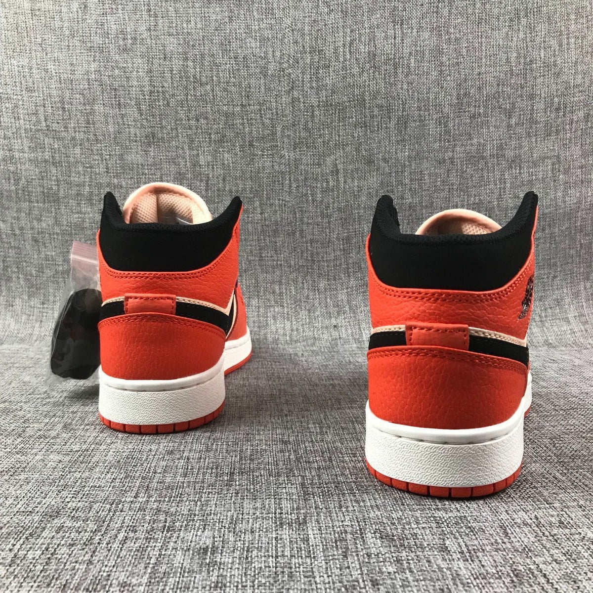 Air Jordan 1 Mid GS Sneakers in Pink and Orange - product image from the listing.