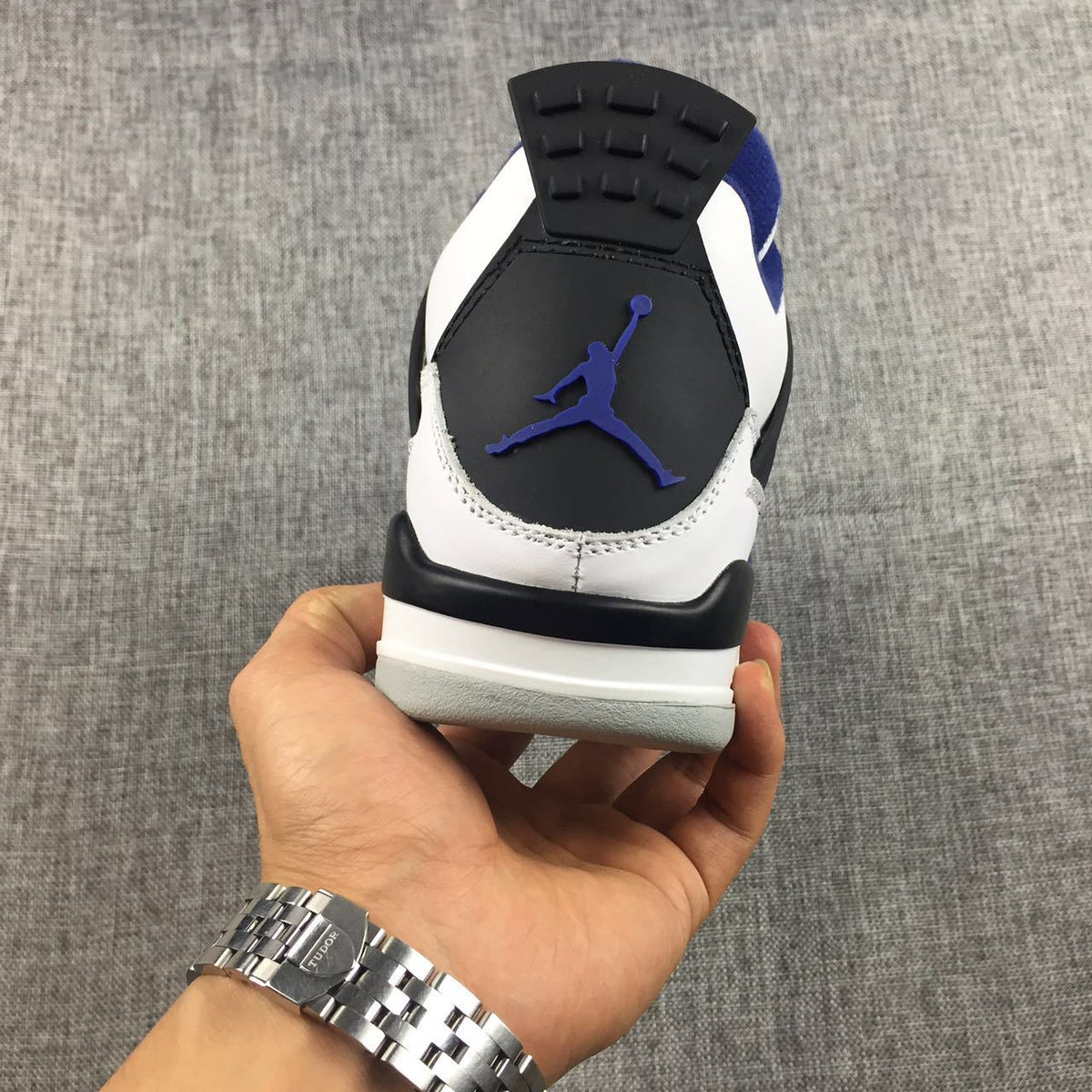 Air Jordan 4 Sneakers in White, Black and Blue - product image from the listing.