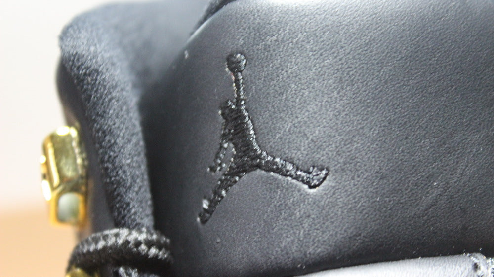 Air Jordan 12 Wings Black White Gold Sneakers 848692-033 - product image from the listing.