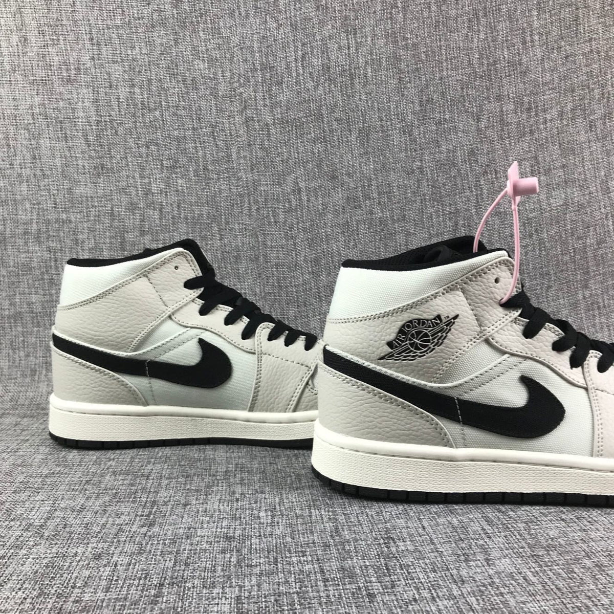 Air Jordan 1 Mid High-Top Sneakers in Grey and Black - product image from the listing.