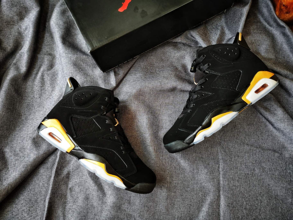 Air Jordan 6 High-Top Sneakers in Black and Gold - product image from the listing.