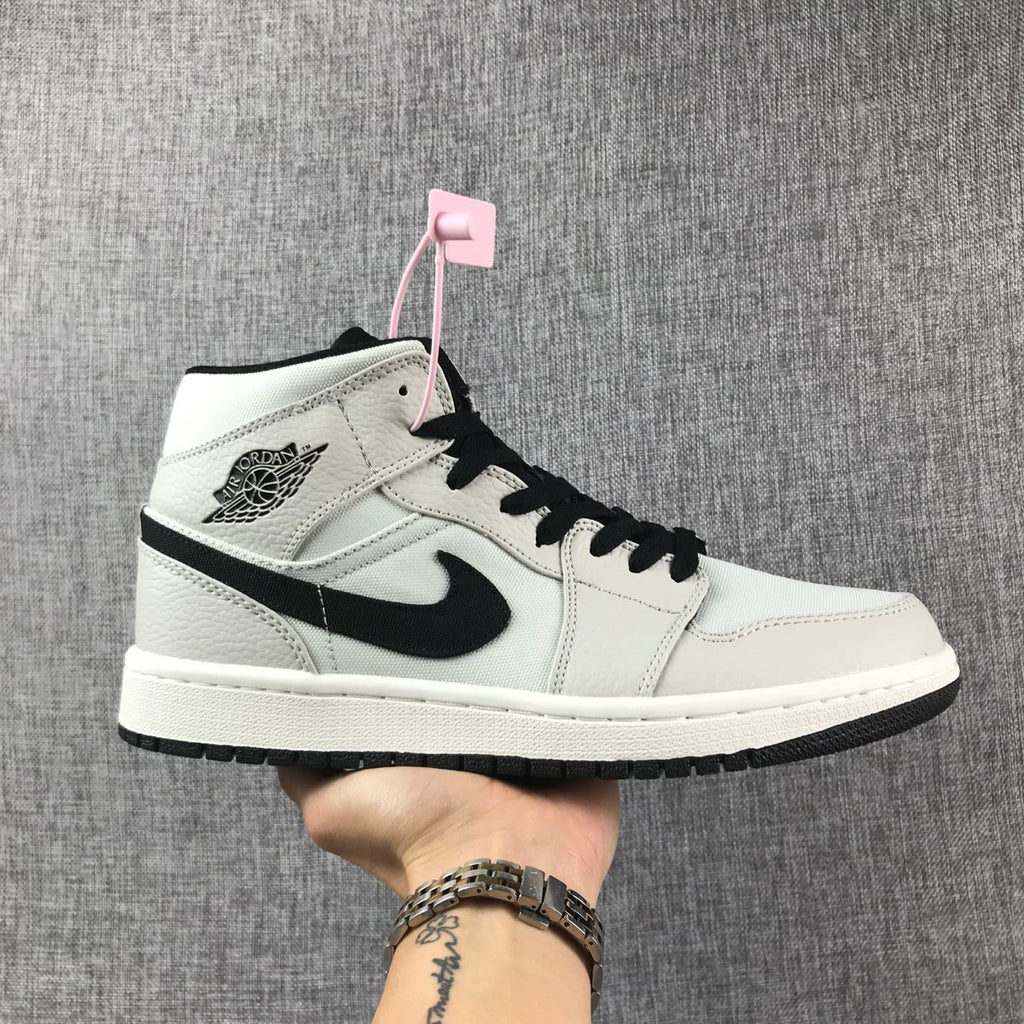 Air Jordan 1 Mid High-Top Sneakers in Grey and Black - product image from the listing.
