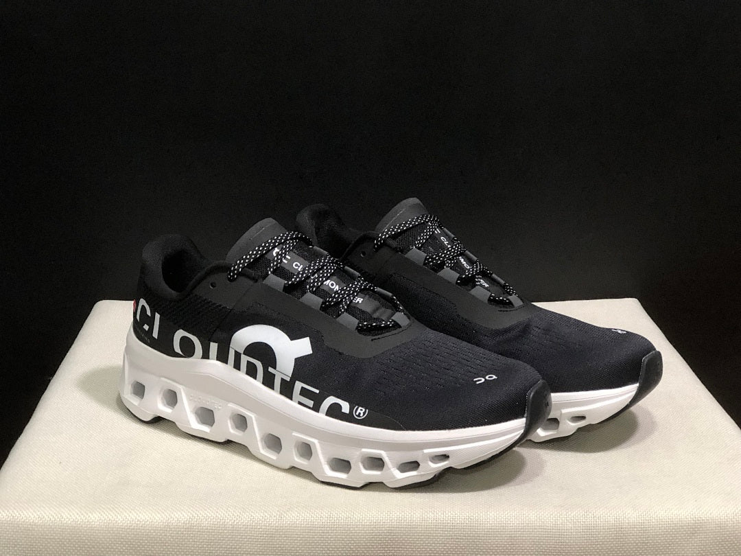 On Cloudmonster Running Sneakers in Black and White - product image from the listing.