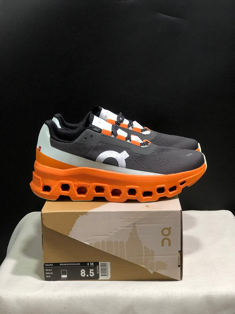 On Cloudmonster Running Shoes in Black Orange - product image from the listing.