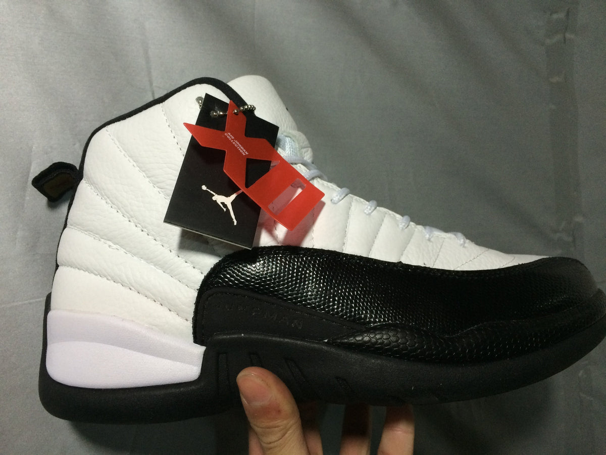Air Jordan 12 Retro White and Black High-Top Sneakers - product image from the listing.
