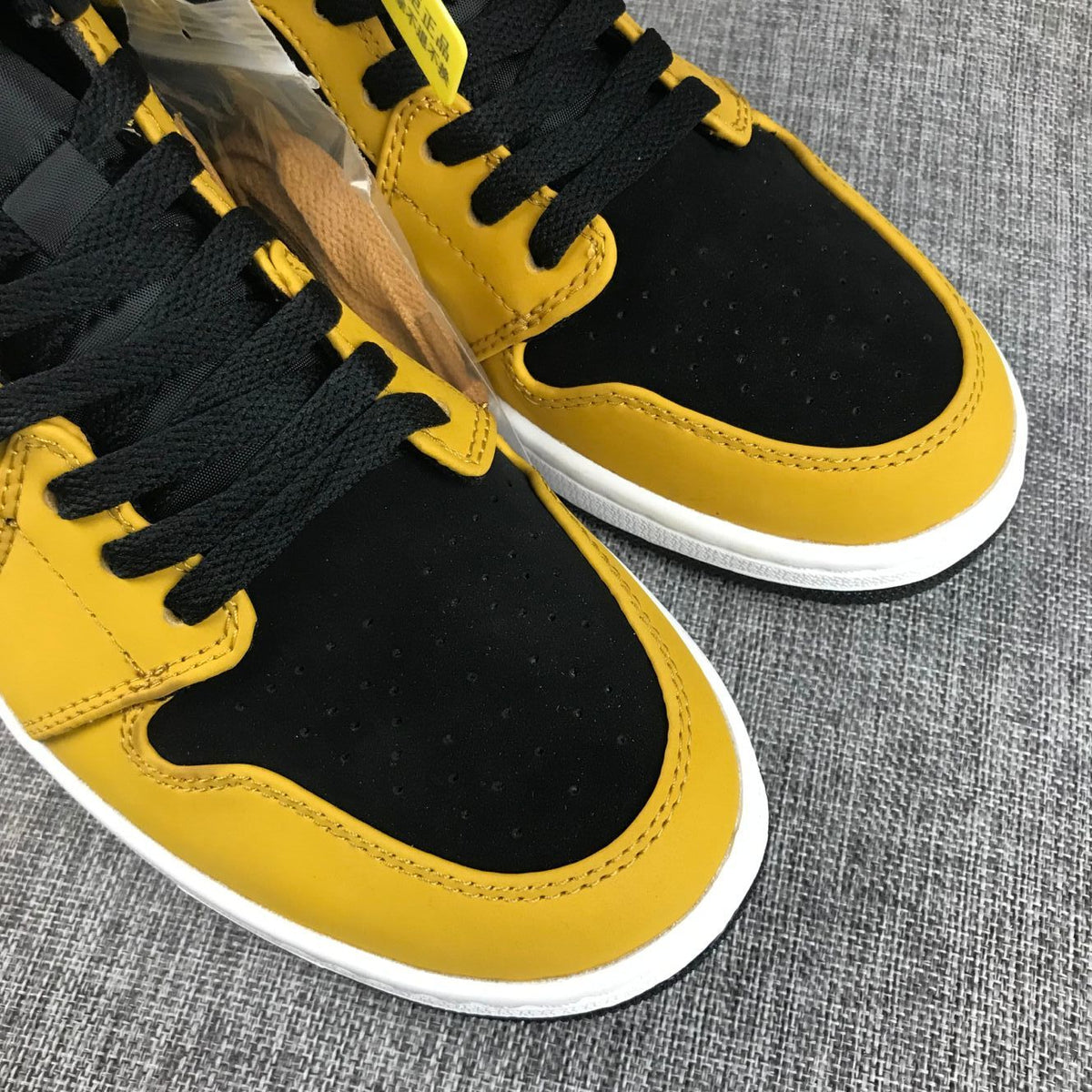 Air Jordan 1 Mid Sneakers in Black and Yellow - product image from the listing.