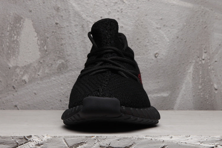 Yeezy Boost 350 V2 Black Knit Trainers with Red Accents - product image from the listing.