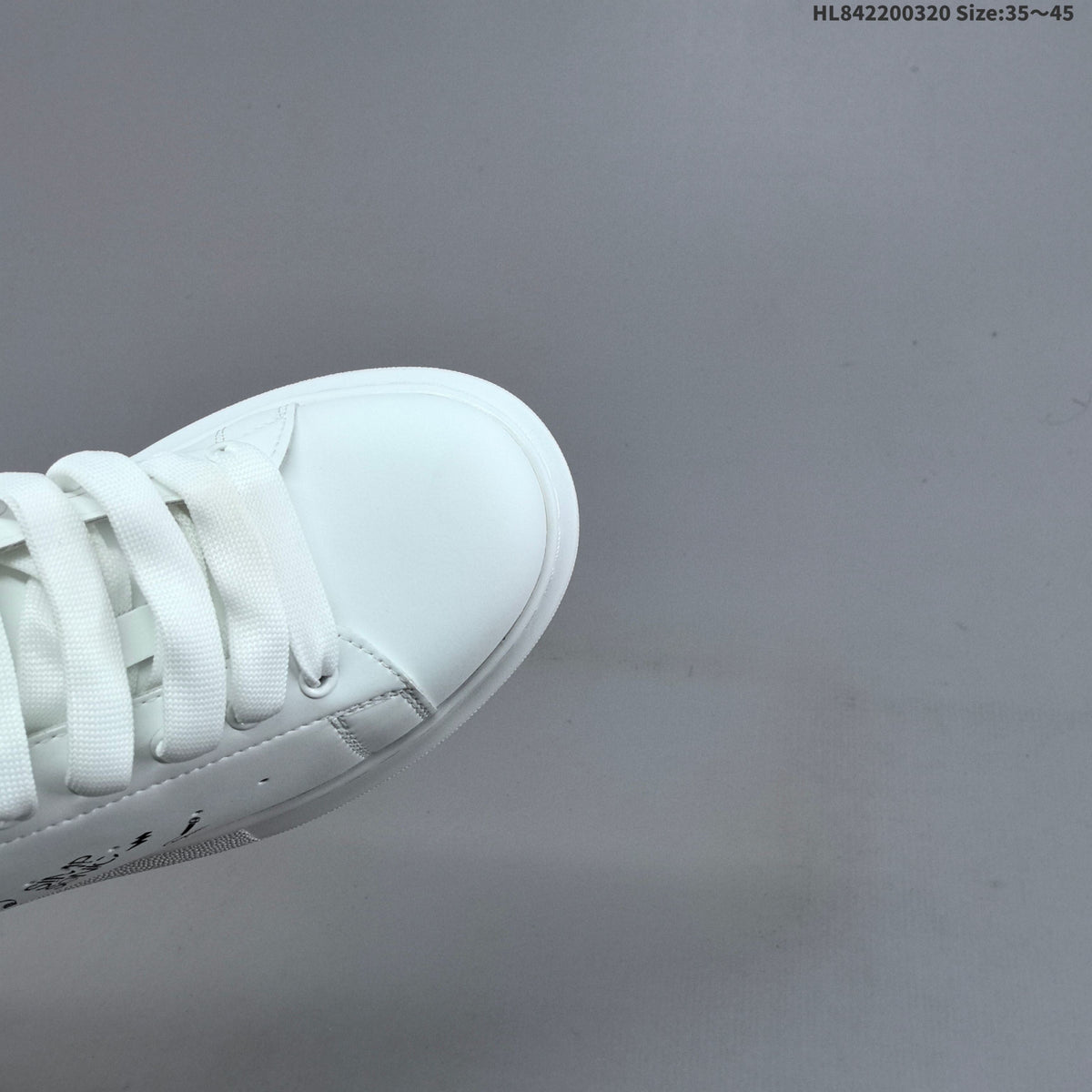 Alexander McQueen Oversized Low-Top Sneakers, in White and Black - product image from the listing.
