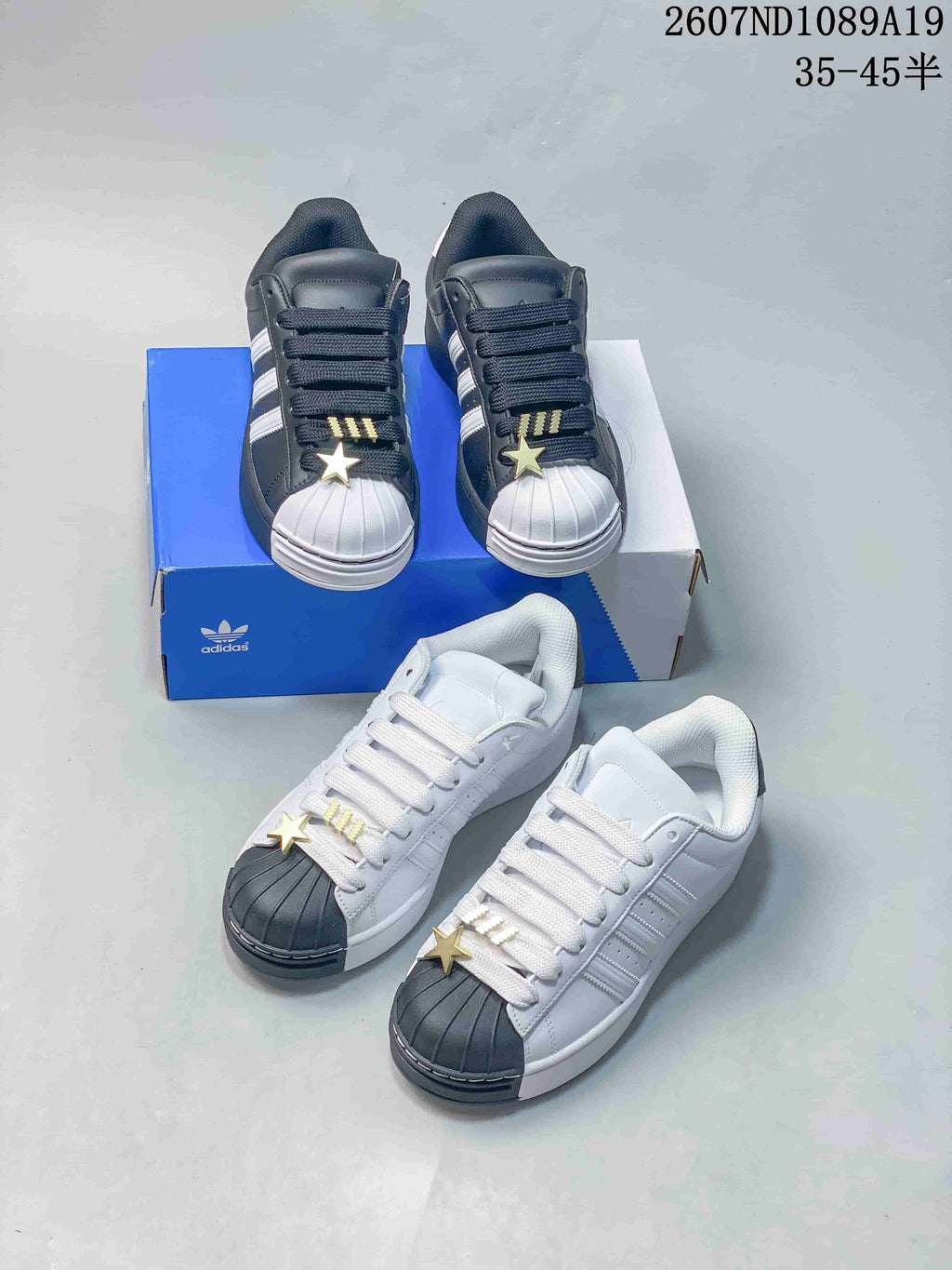 adidas Superstar Shell-Toe Sneakers in Black and White - product image from the listing.