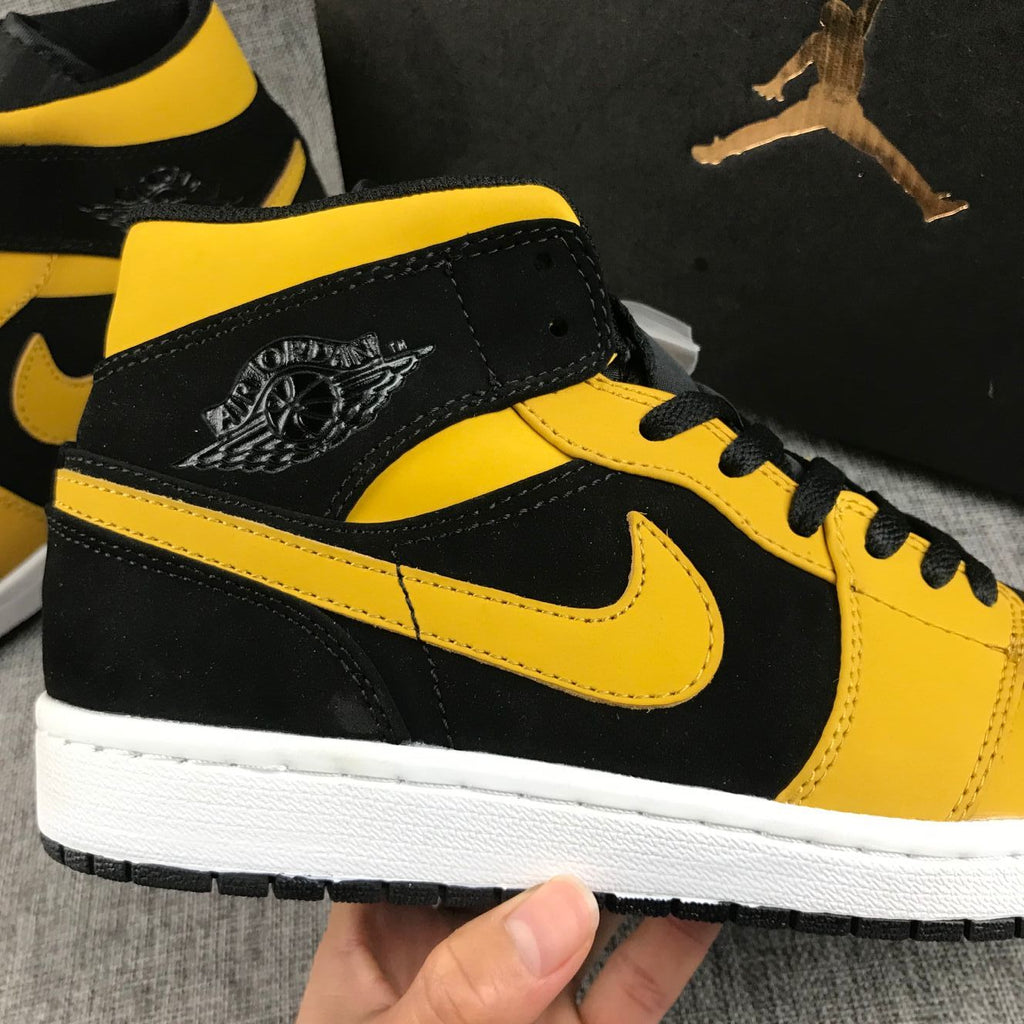 Air Jordan 1 Mid Sneakers in Black and Yellow - product image from the listing.