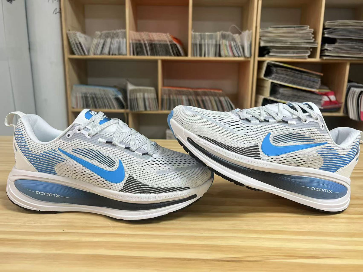 Nike Vomero 18 Running Shoes in White Blue - product image from the listing.