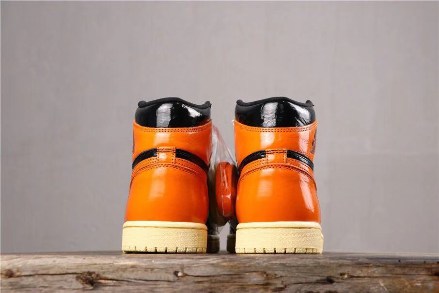 Air Jordan 1 Retro High OG Sneakers in Black and Orange - product image from the listing.