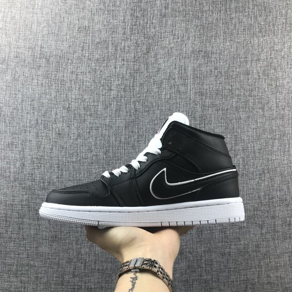 Air Jordan 1 Mid Sneakers in Black and White 852542-016 - product image from the listing.