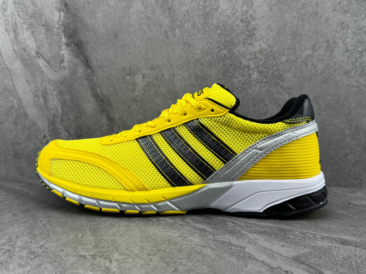 adidas Yellow Mesh Low-Cut Sneakers with Three Stripes - product image from the listing.